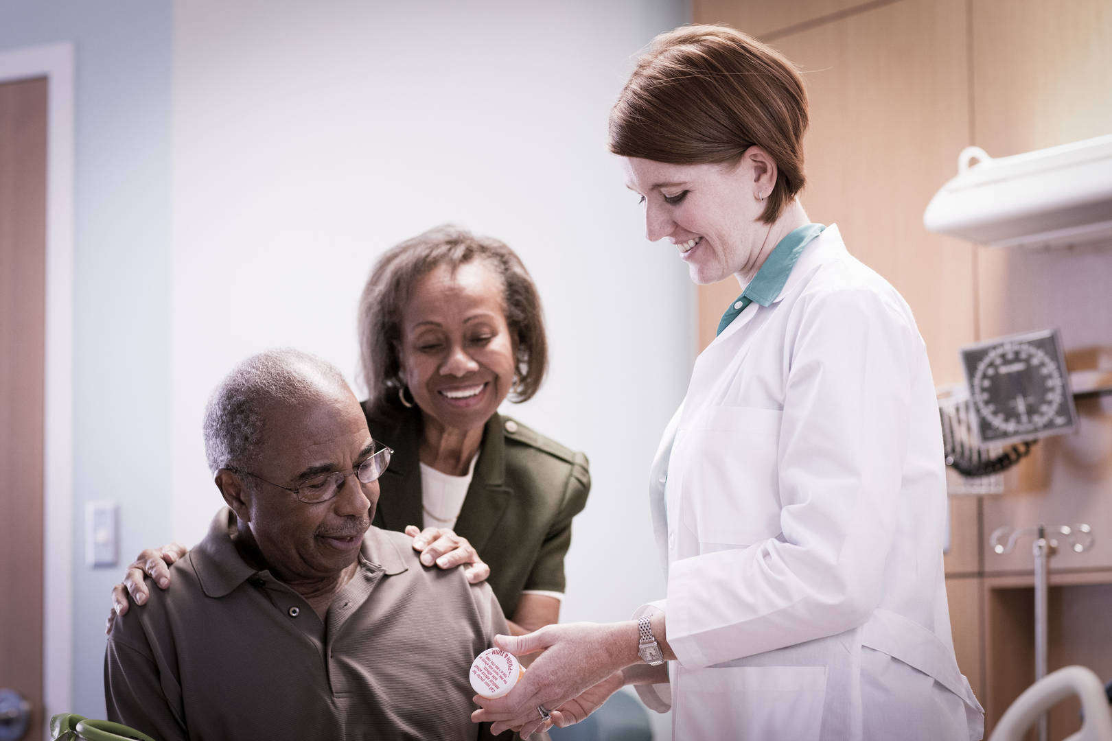 Patient and Wife discussing medication with Physician
